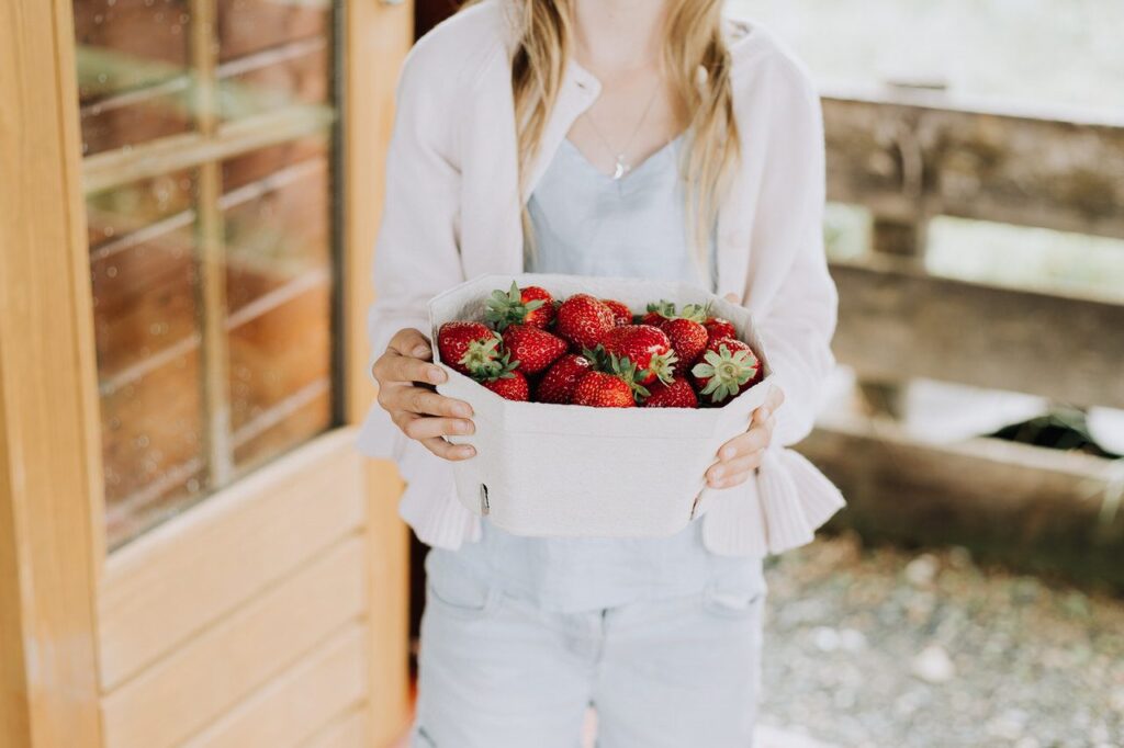 Selling strawberries from a fruit and vegetable stall