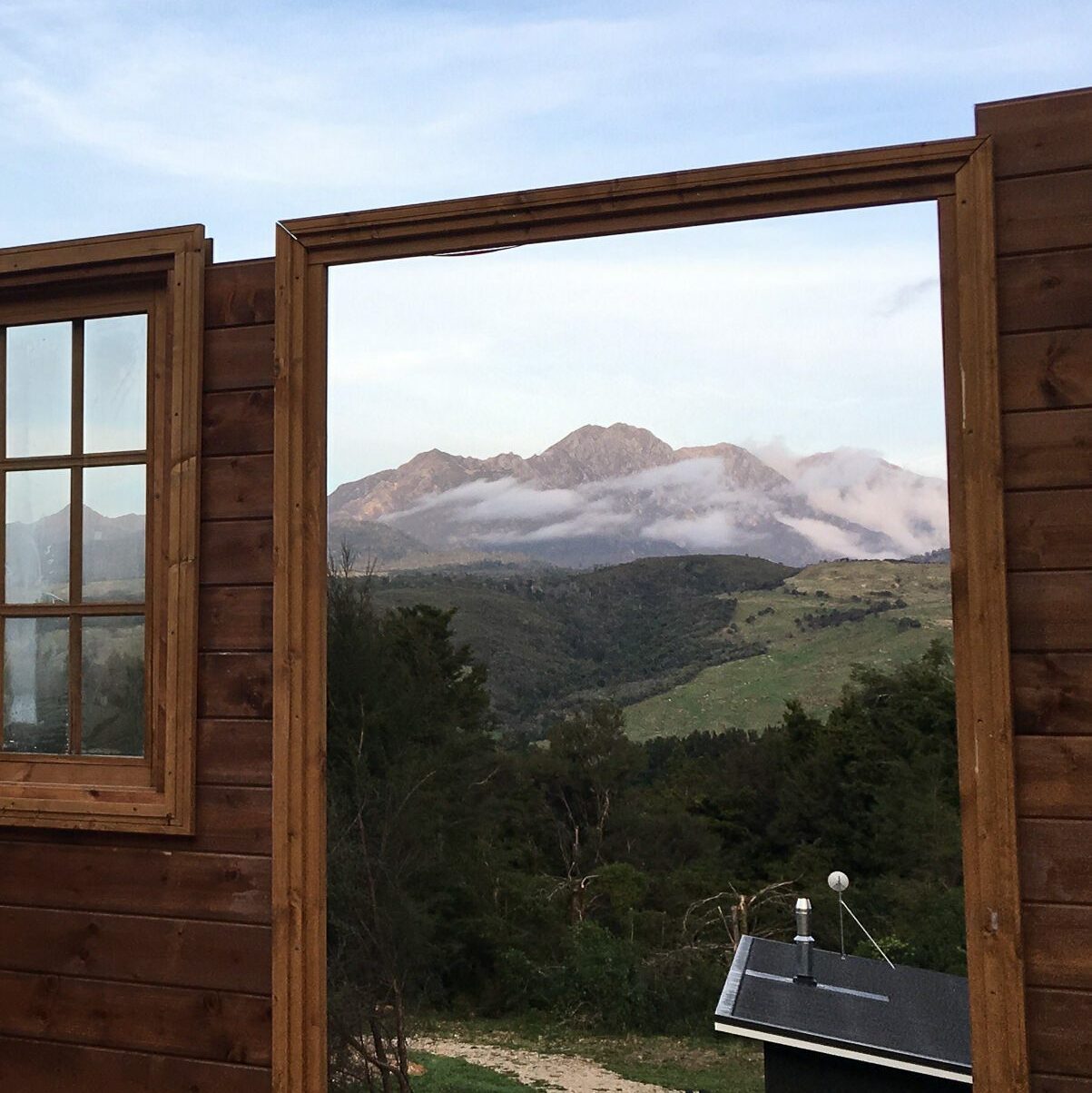 Log cabin being built with farm views