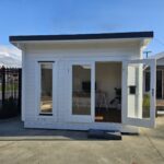 outside of painted tussock display cabin home office with door open