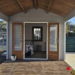 outside of star cabin canopy display with french double doors and painted a light grey