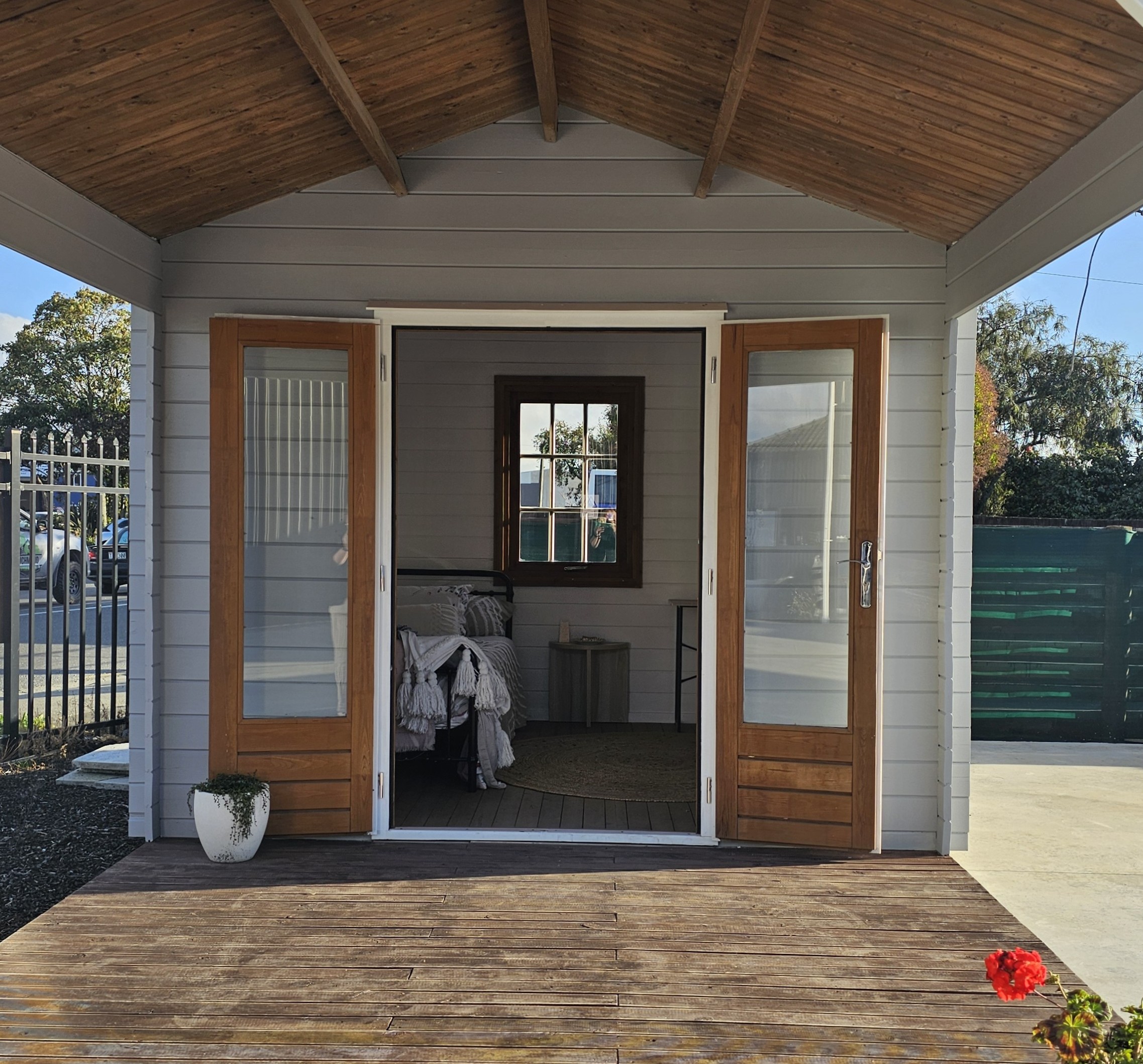 outside of star cabin canopy display with french double doors and painted a light grey