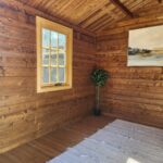 inside of unpainted star cabin display home office with casement window