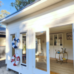 outside of painted poolhouse themed alpine display cabin