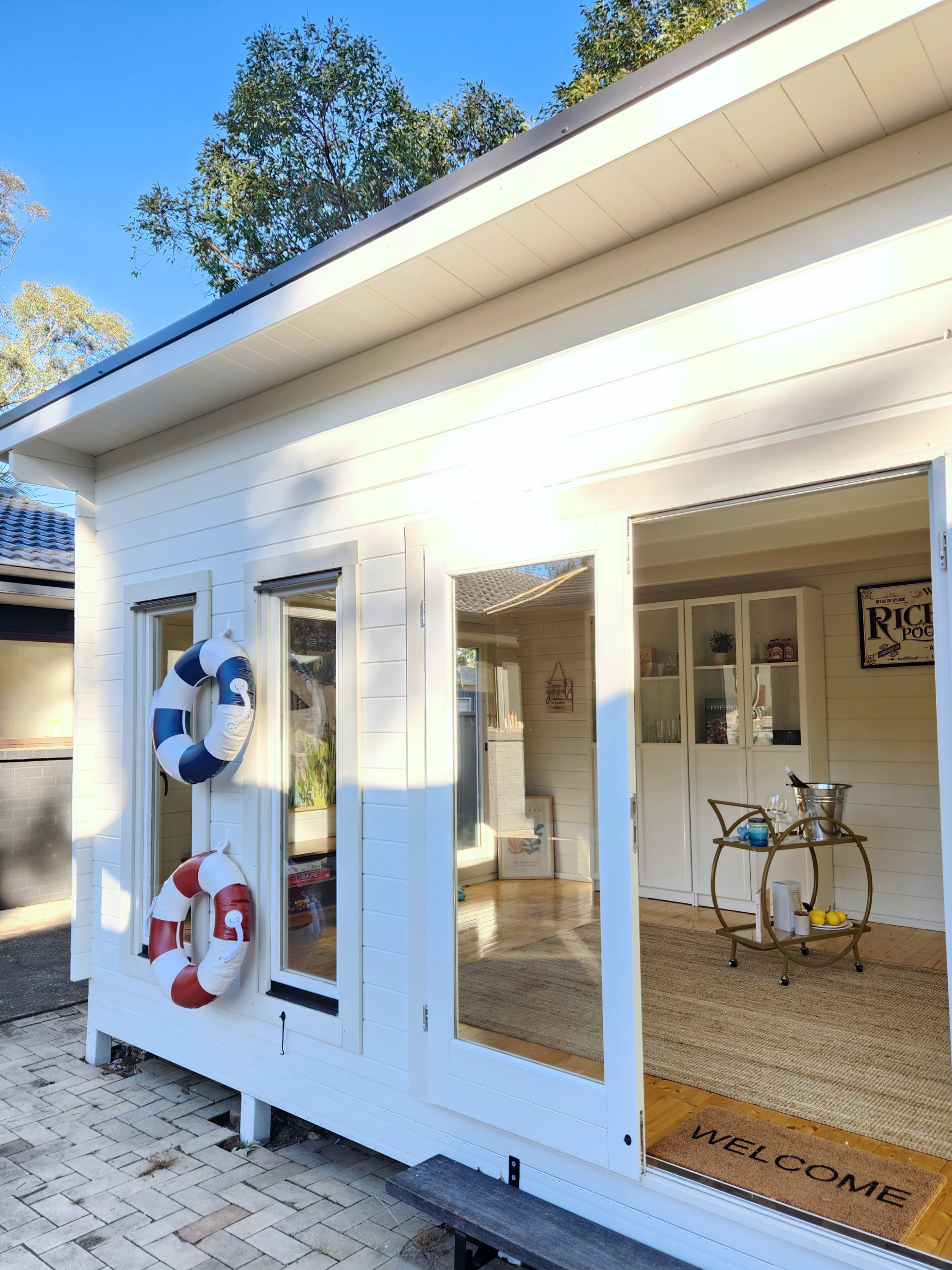 outside of painted poolhouse themed alpine display cabin