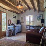 inside of woodland cabin used as backyard retreat with open casement window