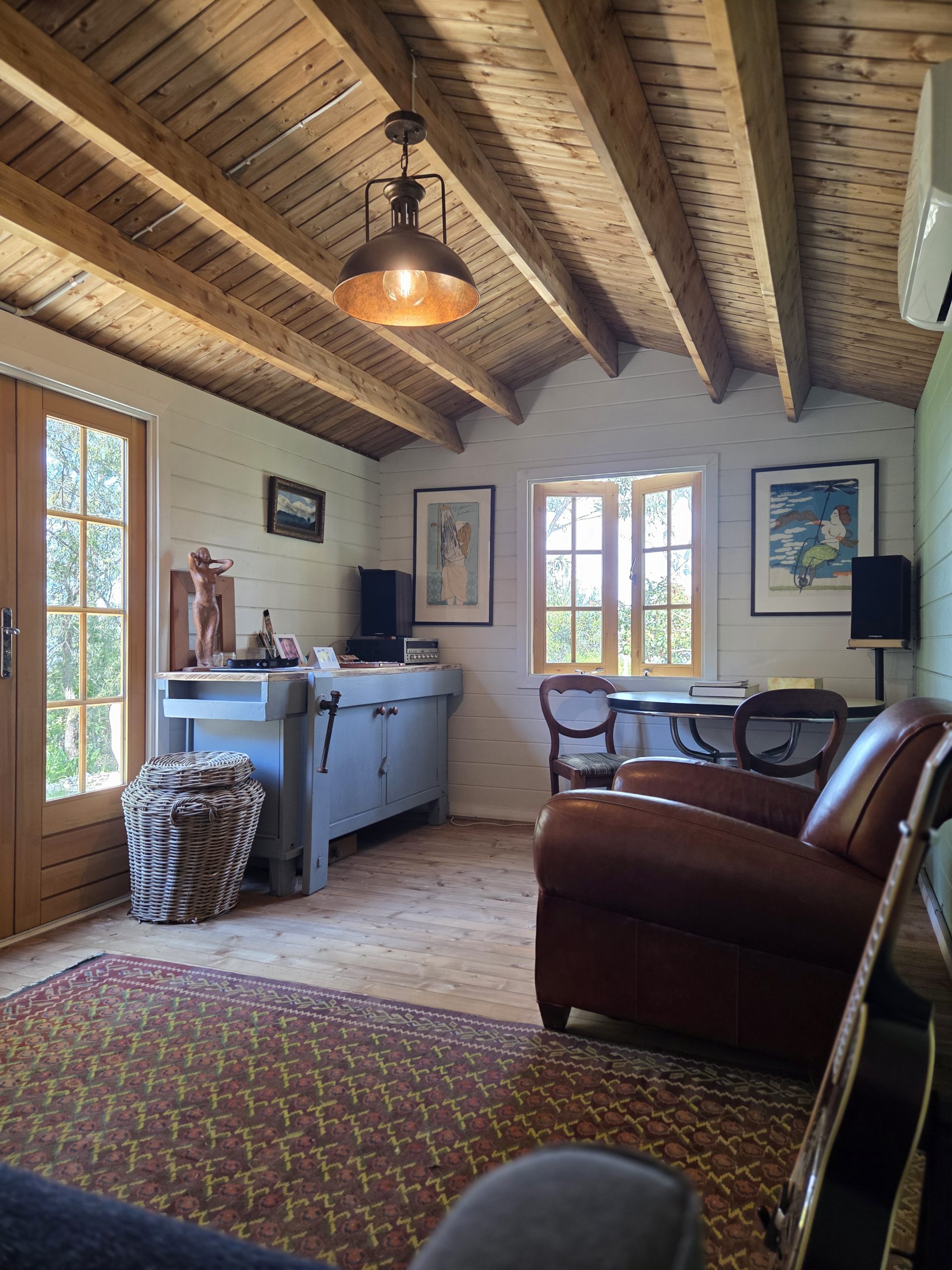 inside of woodland cabin used as backyard retreat with open casement window