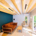 inside of alpine cabin art studio with tilt and turn windows and door open