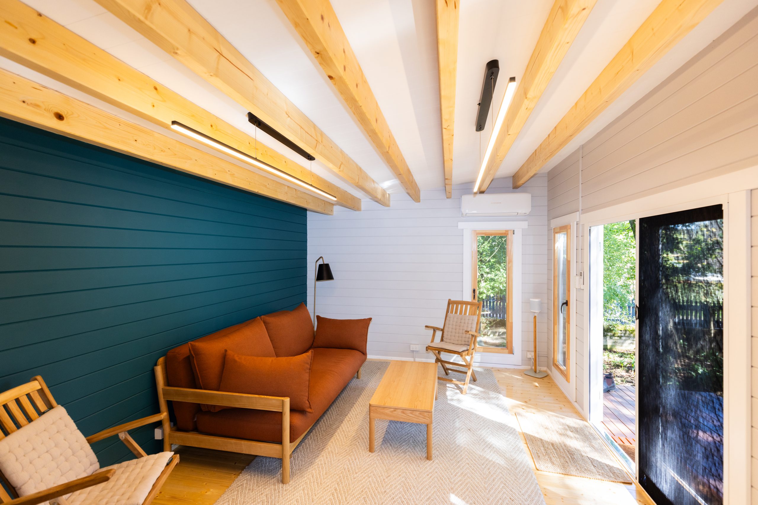 inside of alpine cabin art studio with tilt and turn windows and door open