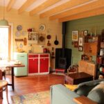 inside of yellow alpine cabin sleepout with fireplace