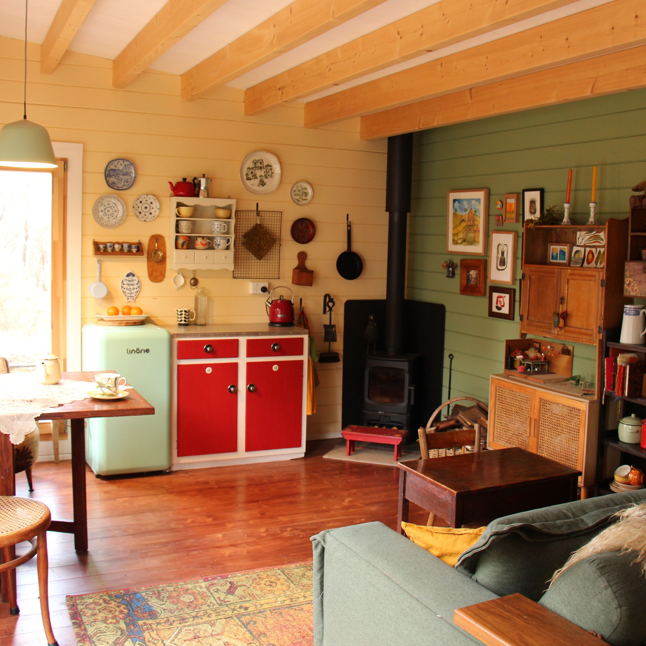 inside of yellow alpine cabin sleepout with fireplace