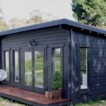 outside of painted alpine cabin with small deck