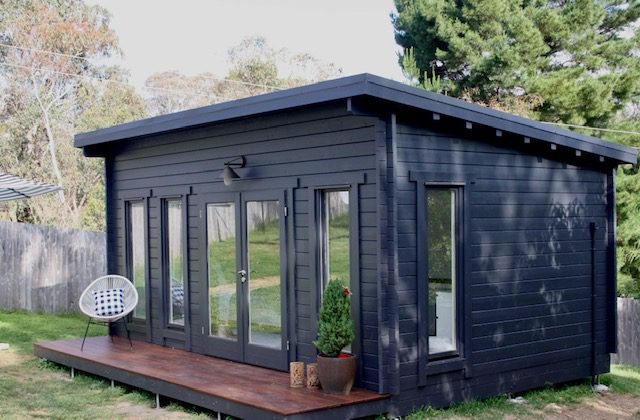 outside of painted alpine cabin with small deck