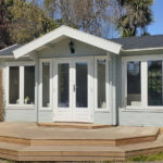 outside of painted brook river cabin used as backyard retreat with custom deck