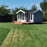 outside of painted brook river cabin used as backyard retreat with custom deck