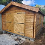 outside tasman display cabin closed barn doors and double window