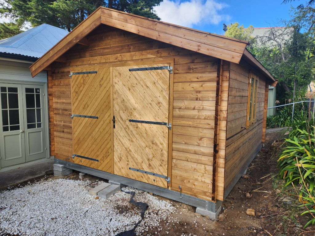 outside tasman display cabin closed barn doors and double window