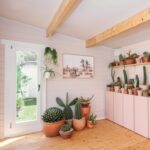 inside of white coastal cabin used as cactus shack business with tilt and turn window