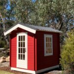 outside of painted cottage garden cabin garden shed with casement window and steel roof and steel subframe