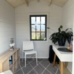 inside of painted cottage garden cabin home office with basement door