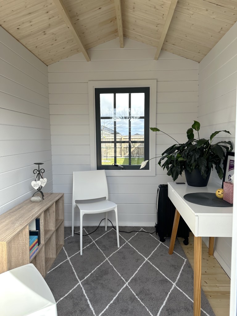 inside of painted cottage garden cabin home office with basement door