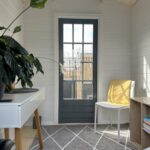 inside of painted cottage garden cabin home office with closed door