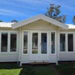 outside of painted display brook river cabin with colourbond roof