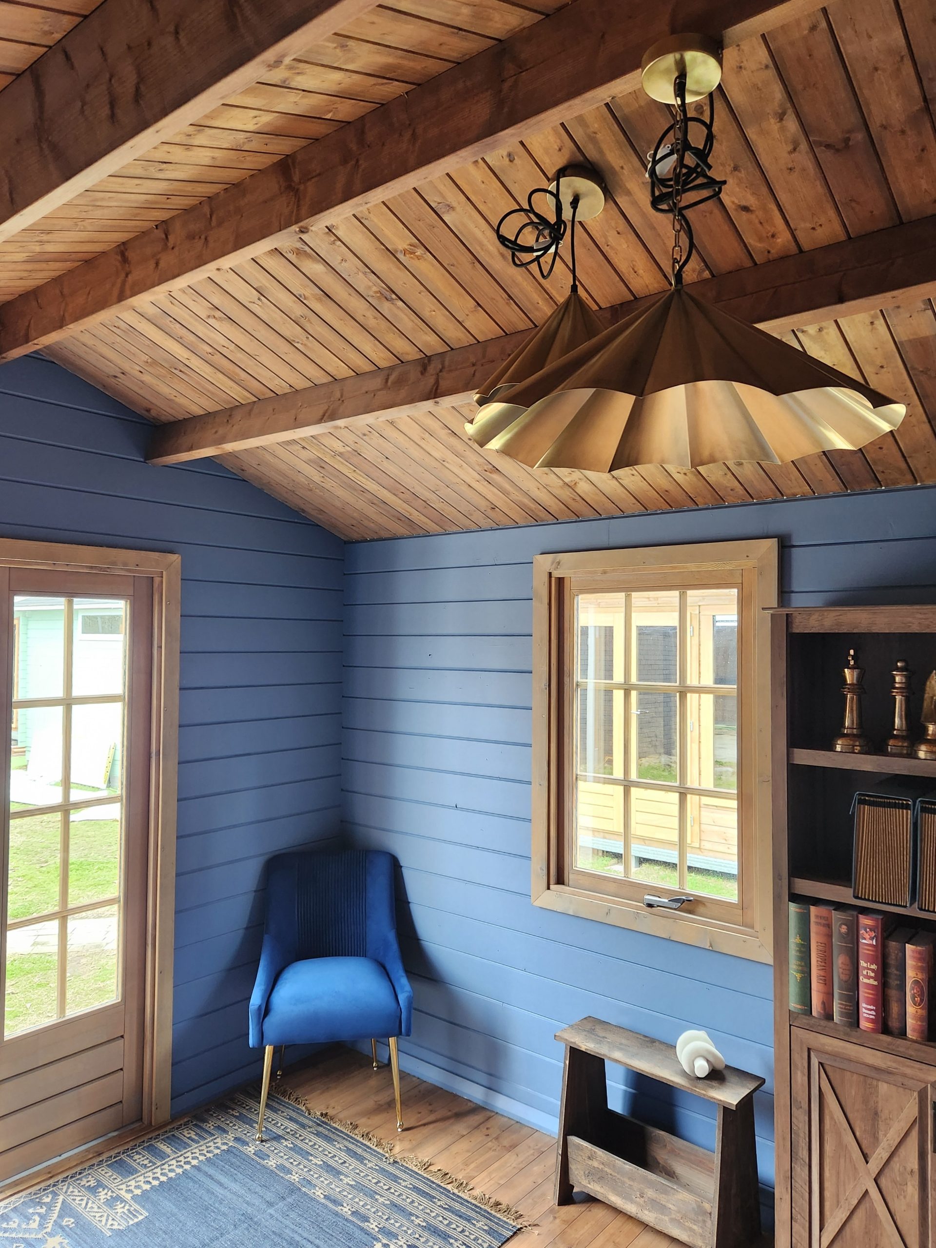 inside of painted star cabin display home office with casement window and brass light