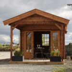 outside of unpainted star canopy display cabin styled as a backyard retreat