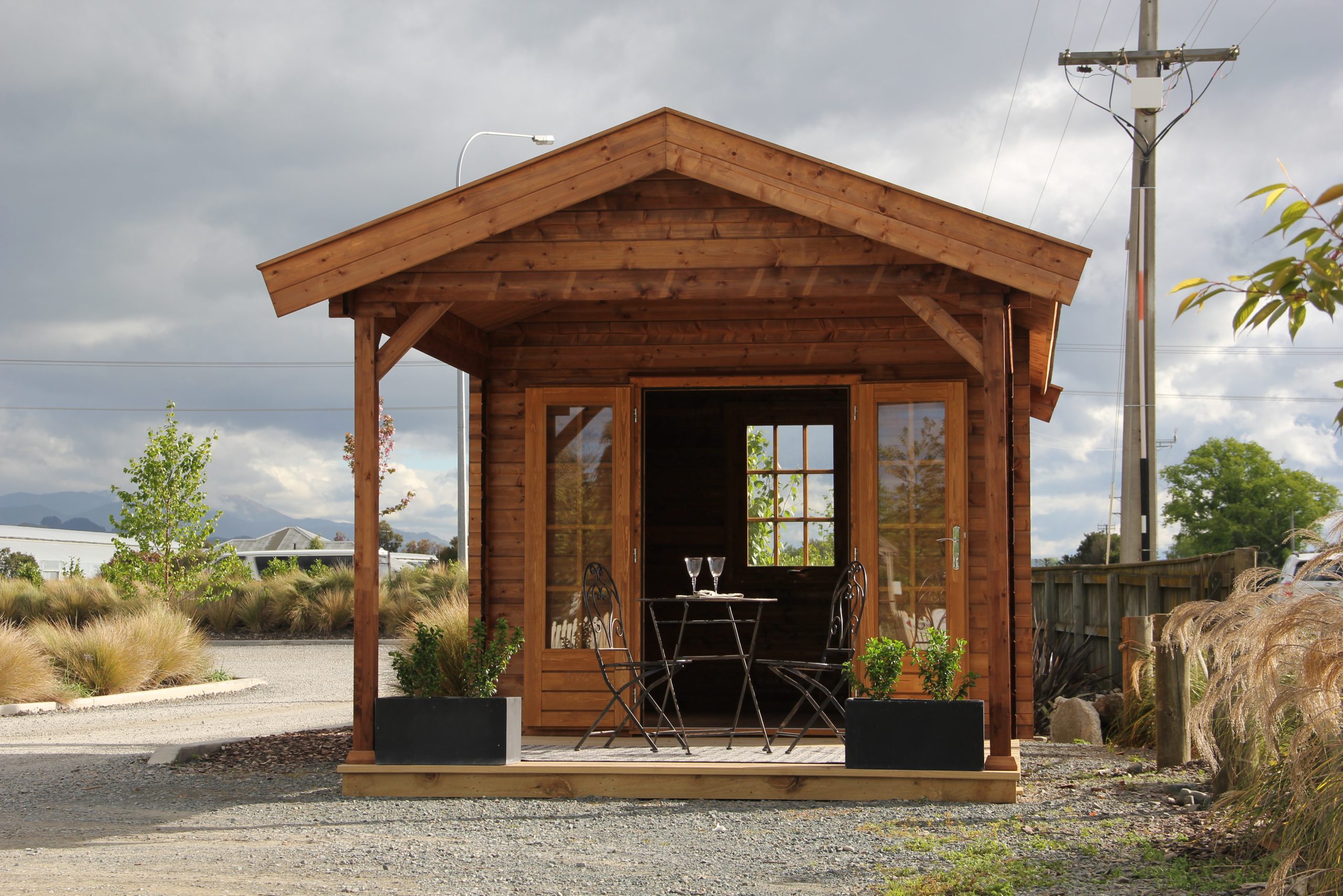 outside of unpainted star canopy display cabin styled as a backyard retreat