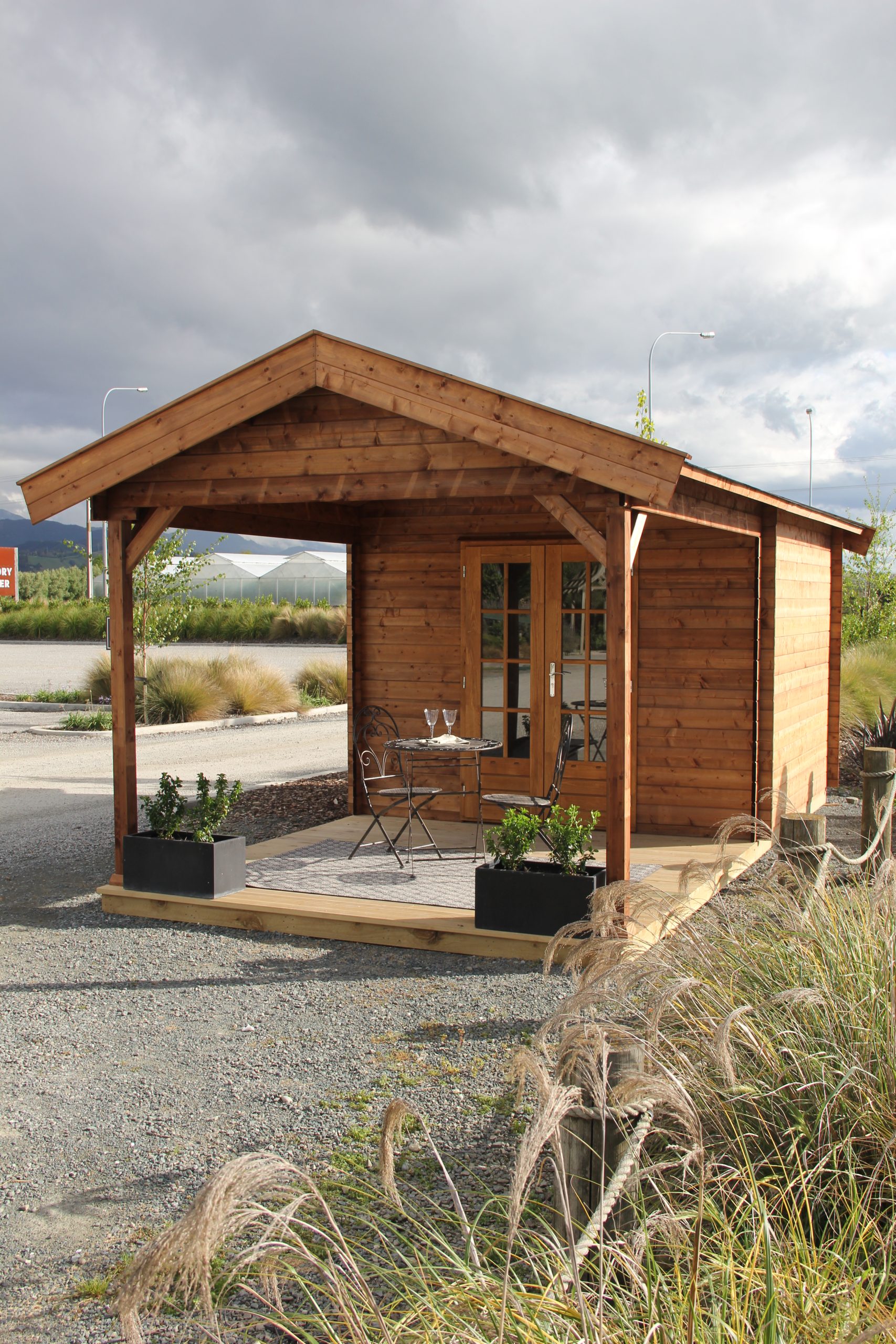 outside of unpainted star canopy display cabin styled as a backyard retreat