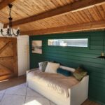 inside painted tasman display cabin with part fixed long window and barn doors