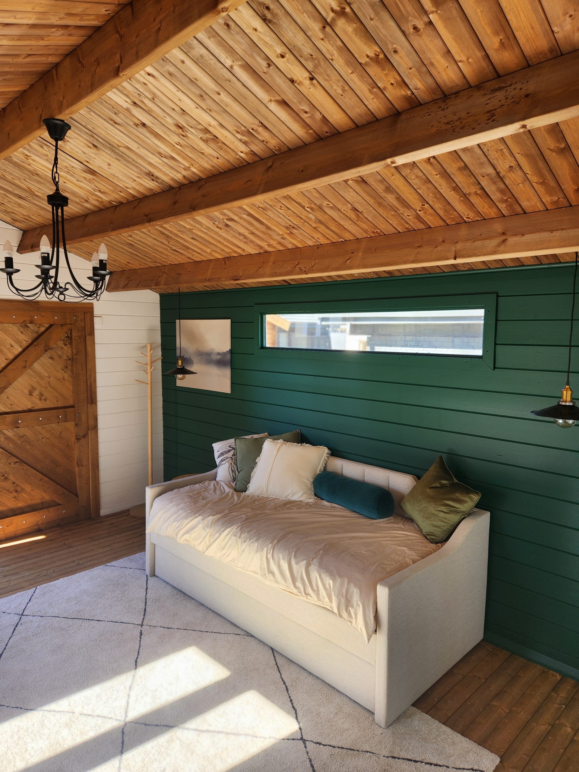 inside painted tasman display cabin with part fixed long window and barn doors
