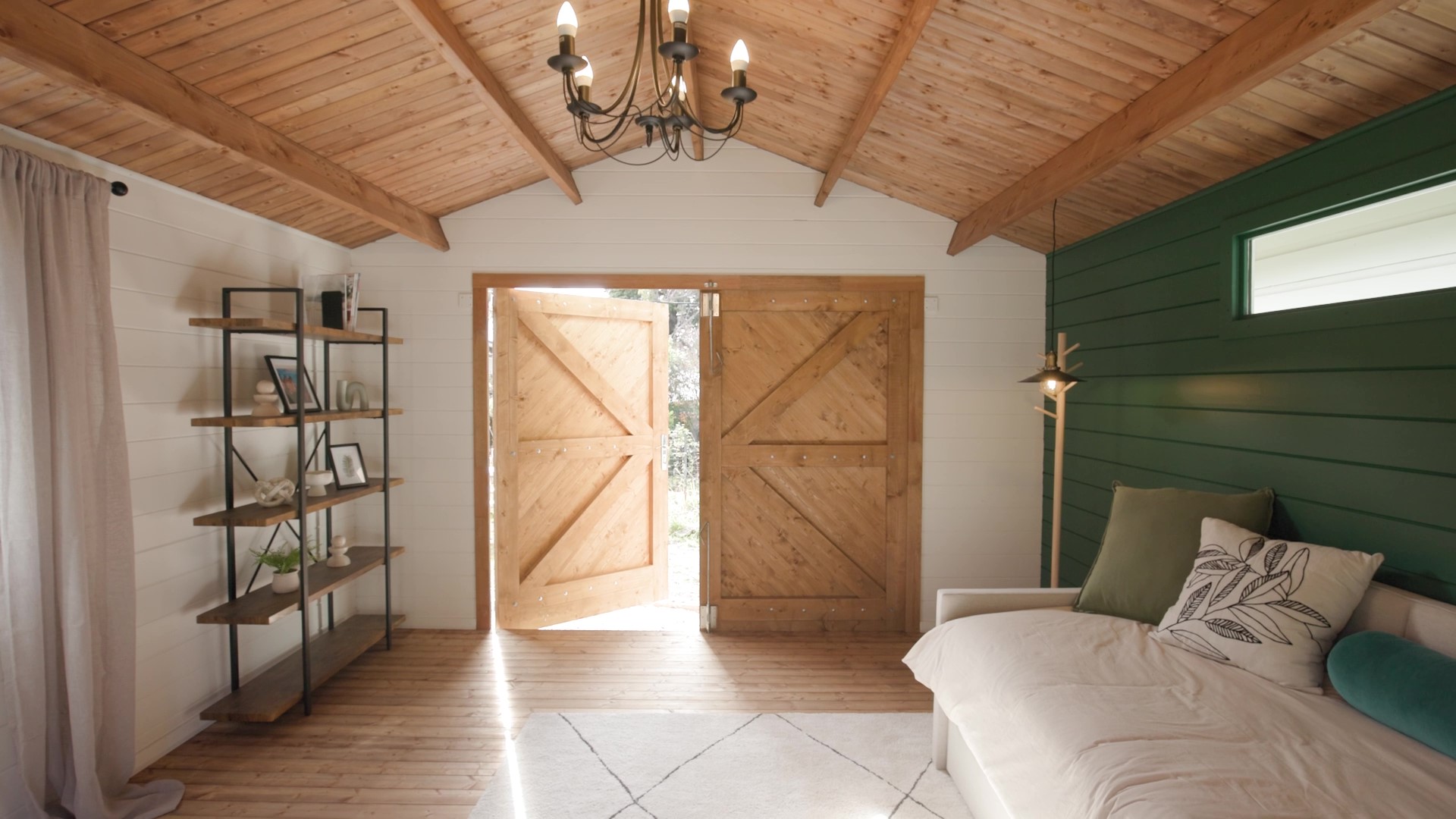 inside of tasman display cabin retreat and reading room with open barn door and lights on