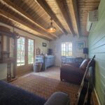 inside of woodland cabin used as backyard retreat with open casement window