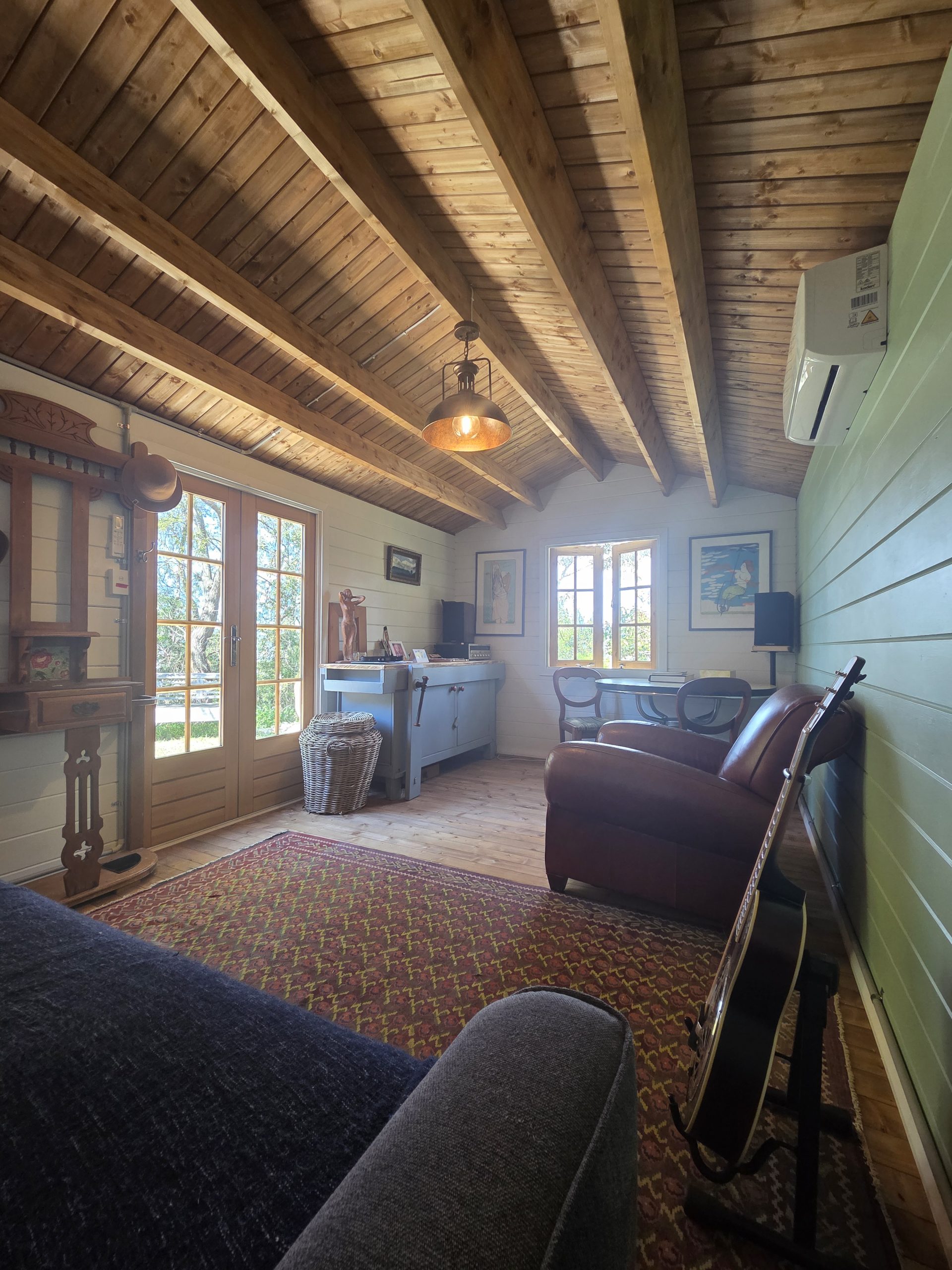inside of woodland cabin used as backyard retreat with open casement window