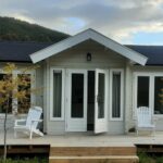 outside of lake cabin as a tiny home with deck