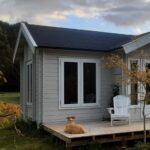 outside of lake cabin as a tiny home with deck
