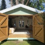 outside of tasman display cabin with open barn doors