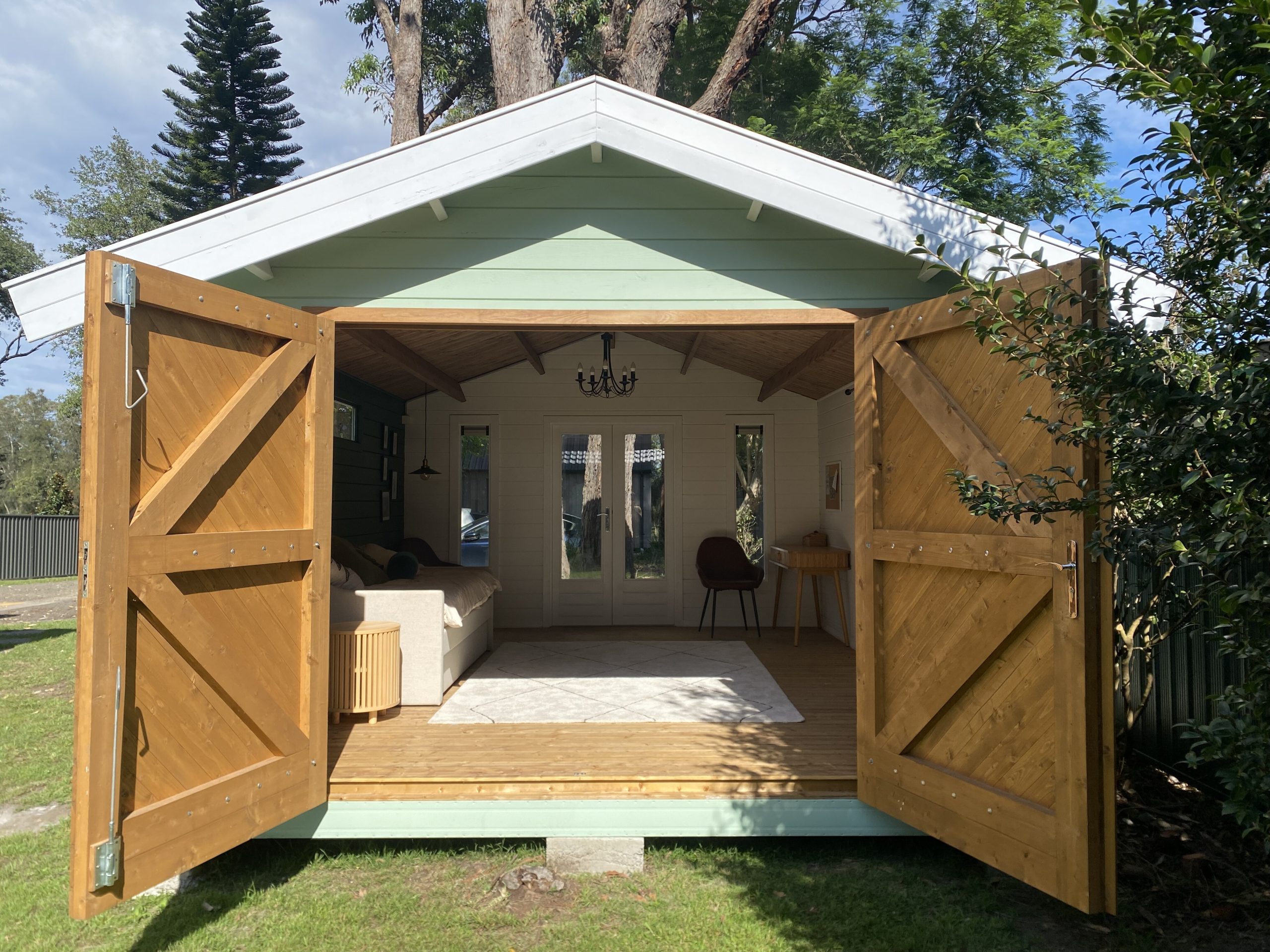outside of tasman display cabin with open barn doors
