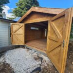 outside tasman display cabin with open barn doors and long window
