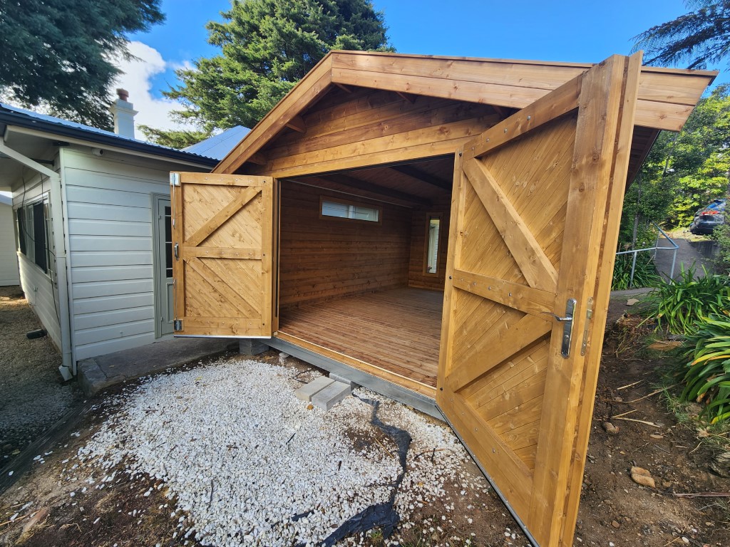 outside tasman display cabin with open barn doors and long window