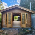 outside tasman display cabin with open french doors