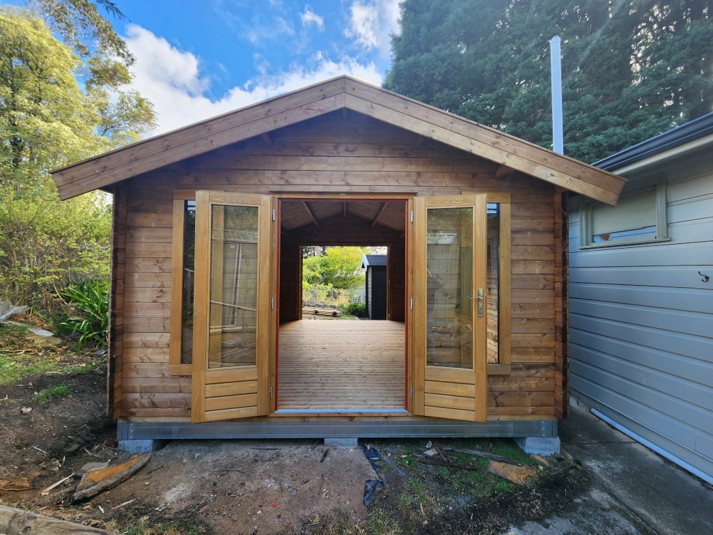 outside tasman display cabin with open french doors