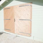 outside and close up of barn doors on tasman display cabin