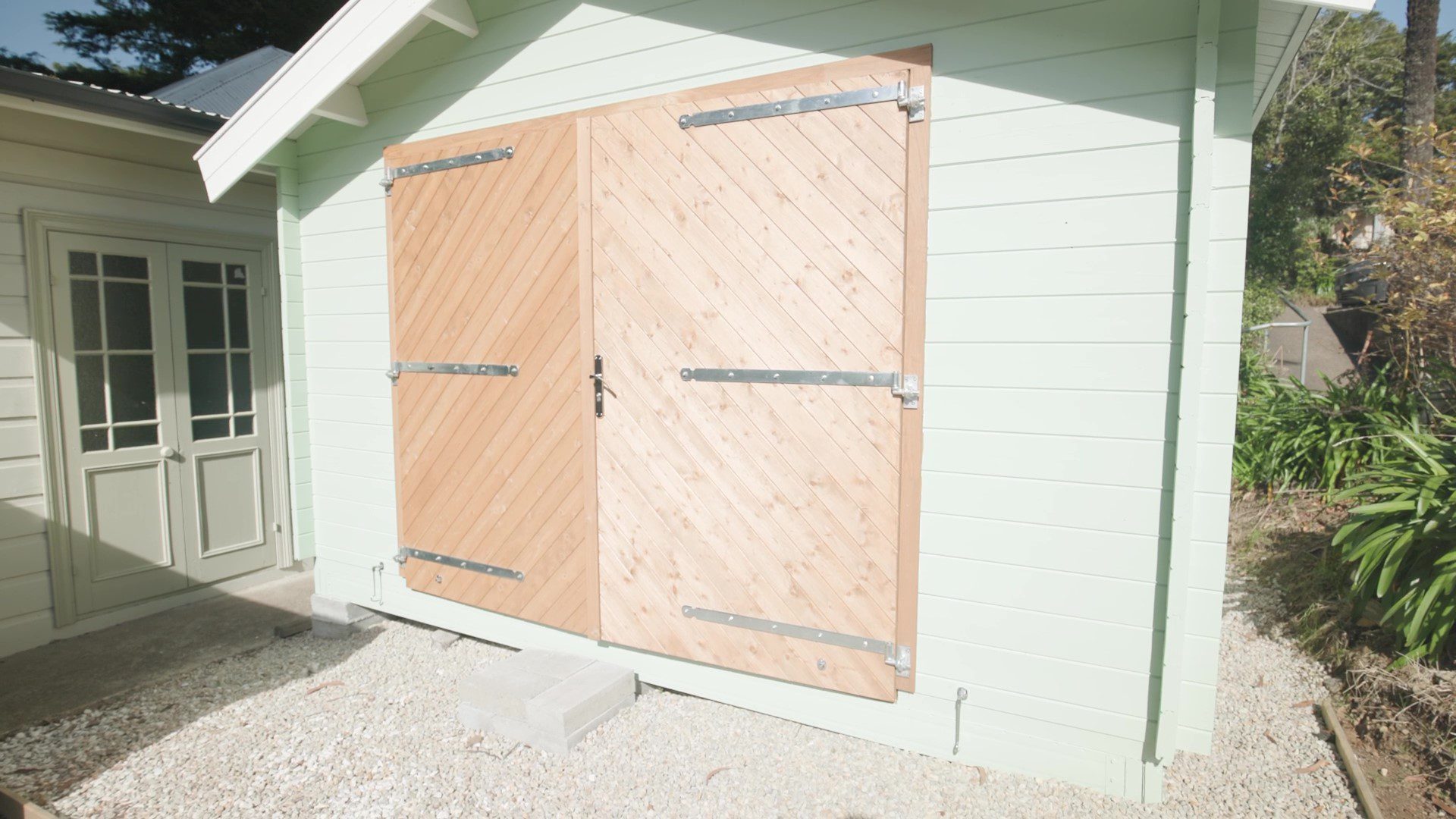 outside and close up of barn doors on tasman display cabin