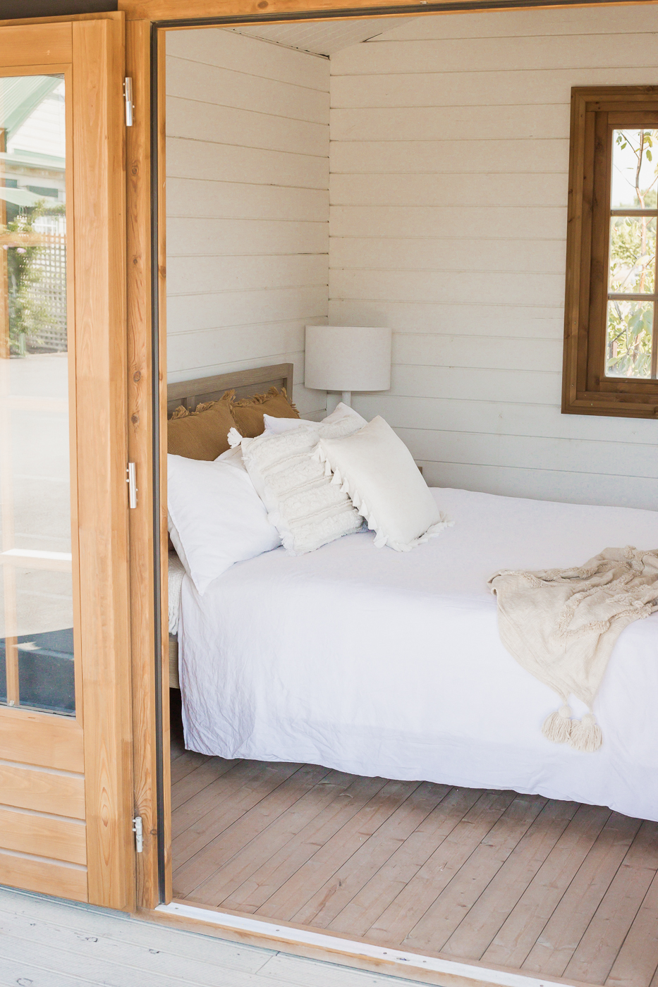 looking into white painted star canopy cabin styled as a bedroom