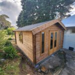 outside tasman display cabin with fixed vented windows and french doors and double window