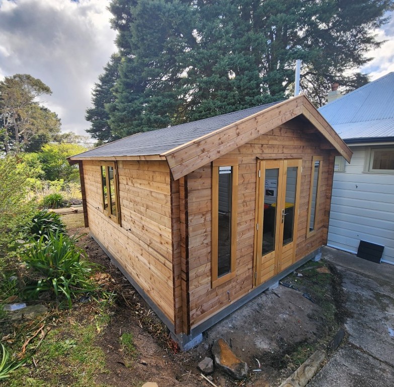 outside tasman display cabin with fixed vented windows and french doors and double window