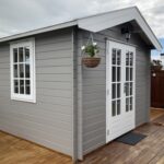 outside of painted star cabin sauna with french doors