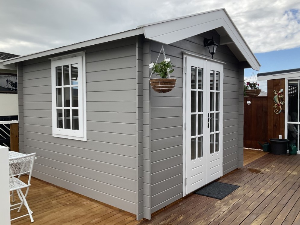 outside of painted star cabin sauna with french doors